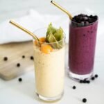 a couple of drinks with fruit and ice cream in them